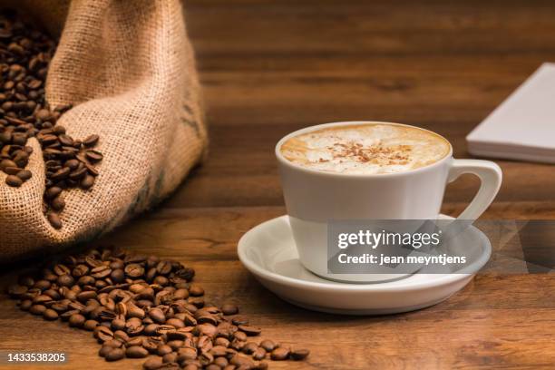 freshly brewed cup of coffee with beans - café au lait stock pictures, royalty-free photos & images