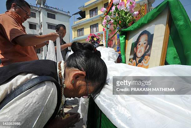 Tibetans in exile bow before a portrait of spiritual leader the Panchen Lama while clebrating his 23rd birth anniversary at the Tibetan Welfare...
