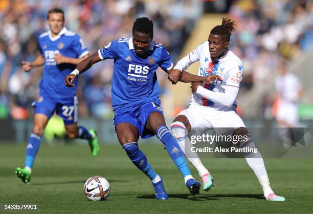 Daniel Amartey of Leicester City is challenged by Wilfried Zaha of Crystal Palace during the Premier League match between Leicester City and Crystal...