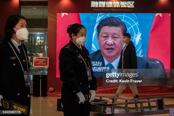 Video screen shows Chinese President Xi Jinping as security is seen at the press centre for the 20th National Congress of the Communist Party of...