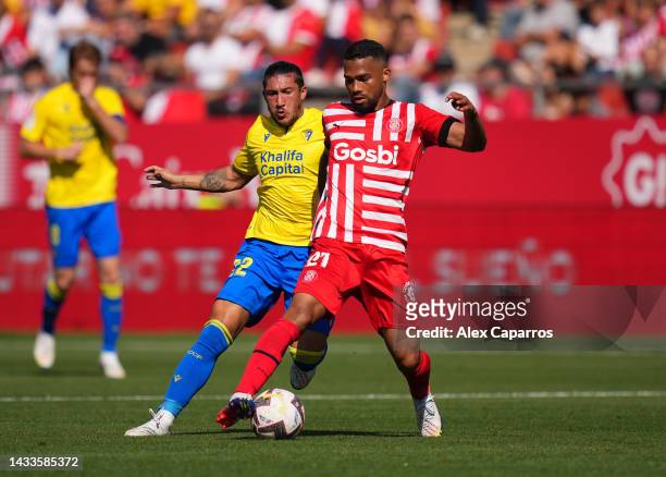 Yangel Herrera of Girona FC is challenged by Alfonso Espino of Cadiz CF during the LaLiga Santander match between Girona FC and Cadiz CF at Montilivi...