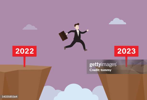 stockillustraties, clipart, cartoons en iconen met businessman jump from 2022 to 2023 - richel