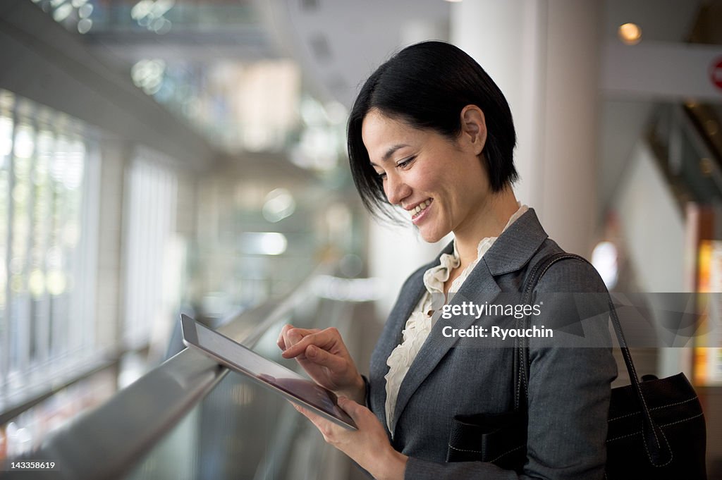 Businesswoman you are using a tablet