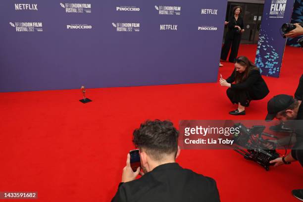 Small replica of Pinocchio can be seen on the red carpet during the "Guillermo Del Toro's Pinocchio" world premiere during the 66th BFI London Film...