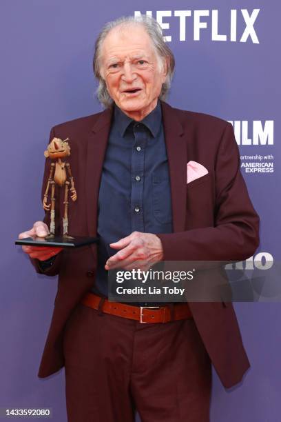 David Bradley poses with a small replica of Pinocchio during the "Guillermo Del Toro's Pinocchio" world premiere during the 66th BFI London Film...