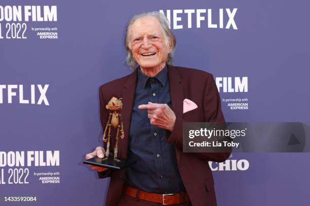 David Bradley poses with a small replica of Pinocchio during the "Guillermo Del Toro's Pinocchio" world premiere during the 66th BFI London Film...