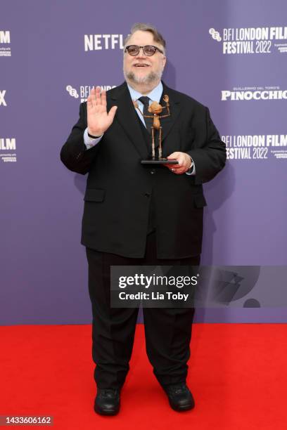 Director Guillermo del Toro poses with a small replica of Pinocchio during the "Guillermo Del Toro's Pinocchio" world premiere during the 66th BFI...