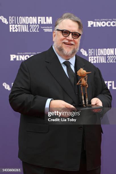 Director Guillermo del Toro poses with a small replica of Pinocchio during the "Guillermo Del Toro's Pinocchio" world premiere during the 66th BFI...