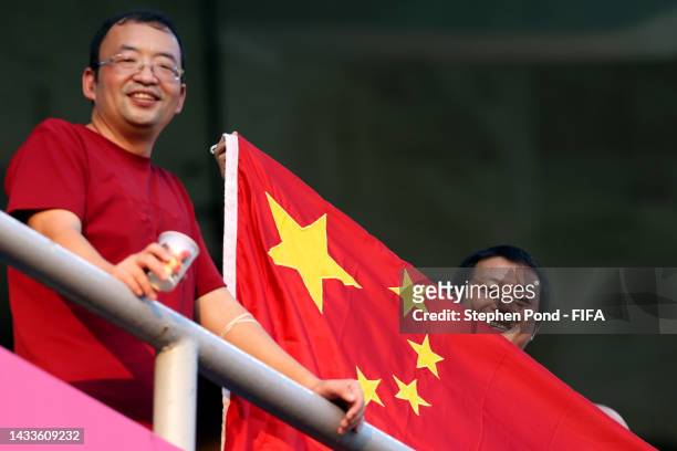 Fan of China holds a flag during the FIFA U-17 Women's World Cup 2022 group stage match between China and Colombia at DY Patil Stadium on October 15,...