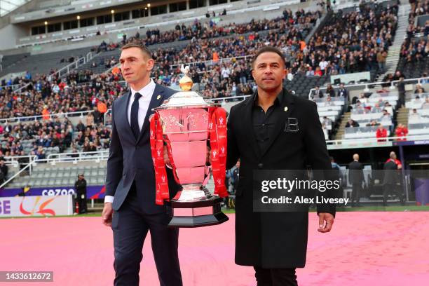 Kevin Sinfield and Jason Robinson carry the Men's Rugby League World Cup 2021 trophy during the opening ceremony of the Rugby League World Cup 2021...