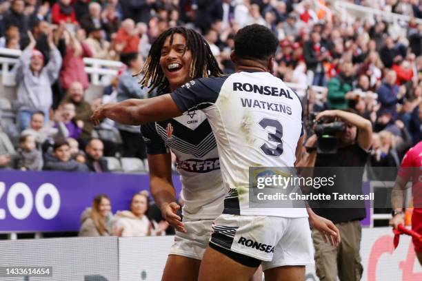 Dom Young of England celebrates with teammate Kallum Watkins after scoring their sides second try during the Rugby League World Cup 2021 Pool A match...
