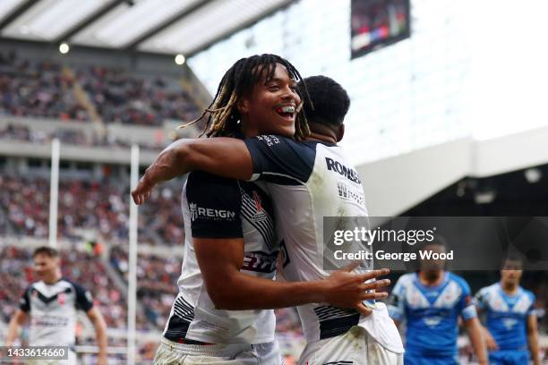 Dom Young of England celebrates with teammate Kallum Watkins after scoring their sides second try during the Rugby League World Cup 2021 Pool A match...