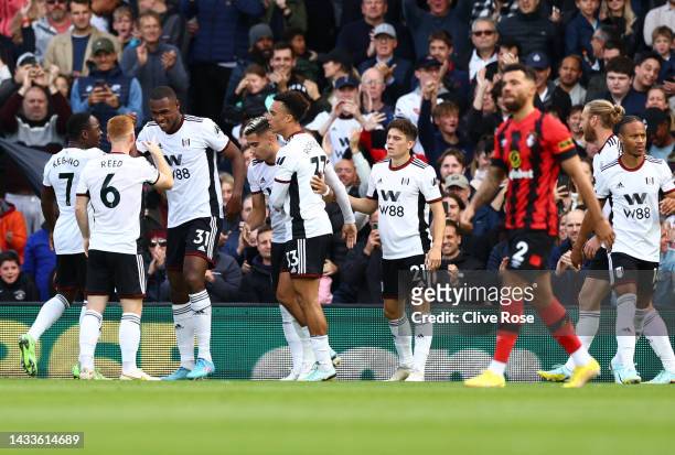 Issa Diop celebrates with Andreas Pereira of Fulham after scoring their team's first goal during the Premier League match between Fulham FC and AFC...