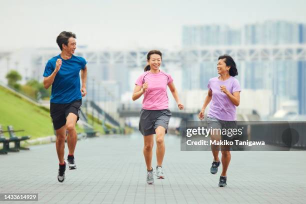 three people running in the city - japan racing stock pictures, royalty-free photos & images