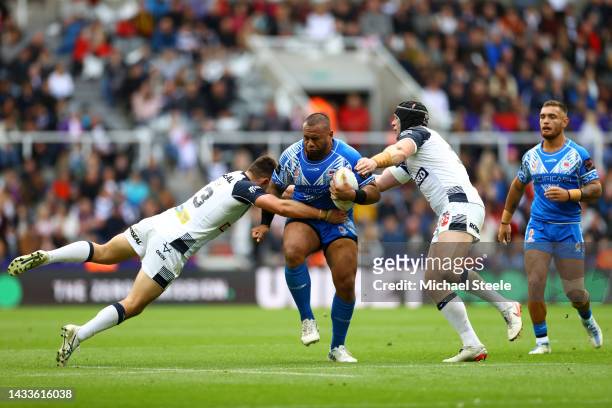 Junior Paulo of Samoa is tackled by Victor Radley and Chris Hill of England during the Rugby League World Cup 2021 Pool A match between England and...