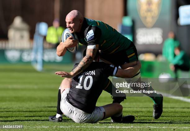 Aaron Hinkley of Northampton Saints is tackled by Brett Connon during the Gallagher Premiership Rugby match between Northampton Saints and Newcastle...