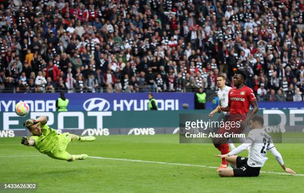 Lucas Alario of Eintracht Frankfurt scores their team's fifth goal past Lukas Hradecky of Bayer 04 Leverkusen during the Bundesliga match between...