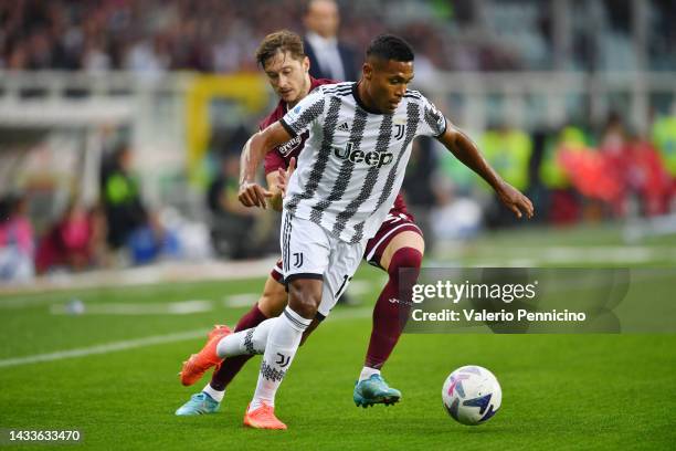 Alex Sandro of Juventus is challenged by Aleksey Miranchuk of Torino FC during the Serie A match between Torino FC and Juventus at Stadio Olimpico di...