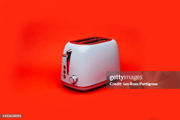 toaster on red background - tostadora fotografías e imágenes de stock