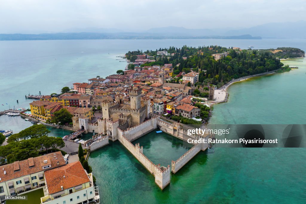 Aerial Drone View town of Sirmione with the Scaligero Castle on Lake Garda. Province of Brescia, Lombardia, Italy.