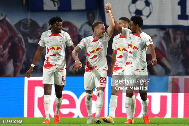 David Raum of RB Leipzig celebrates with teammate Abdou Diallo after scoring their side's second goal during the Bundesliga match between RB Leipzig...