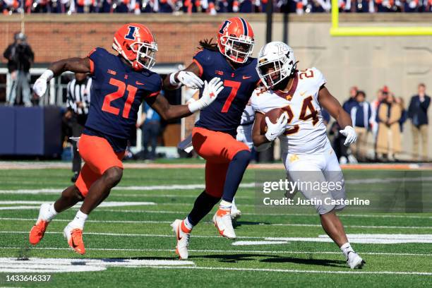 Mohamed Ibrahim of the Minnesota Golden Gophers runs the ball while being chased by Jartavius Martin and Kendall Smith of the Illinois Fighting...