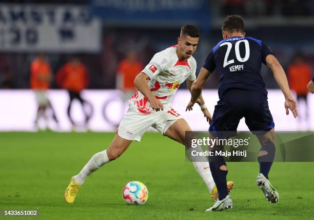 Andre Silva of RB Leipzig is challenged by Marc-Oliver Kempf of Hertha Berlin during the Bundesliga match between RB Leipzig and Hertha BSC at Red...