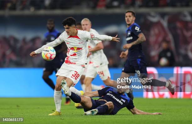 Hugo Novoa of RB Leipzig is challenged by Suat Serdar of Hertha Berlin during the Bundesliga match between RB Leipzig and Hertha BSC at Red Bull...