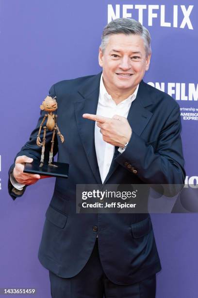 Chief Content Officer of Netflix, Ted Sarandos poses with a small replica of Pinocchio at "Guillermo Del Toro's Pinocchio" world premiere during the...