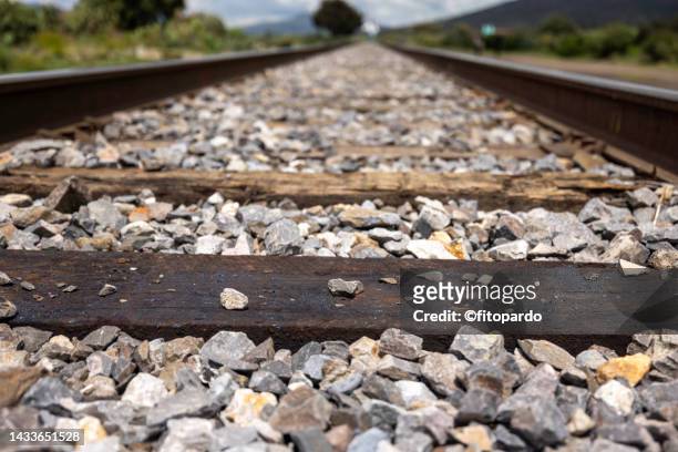 railroad tracks crossing an arid state of mexico - fitopardo stock pictures, royalty-free photos & images