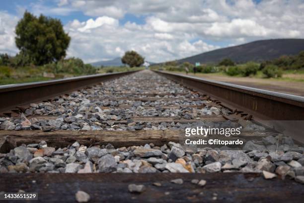 railroad tracks crossing an arid state of mexico - fitopardo stock pictures, royalty-free photos & images
