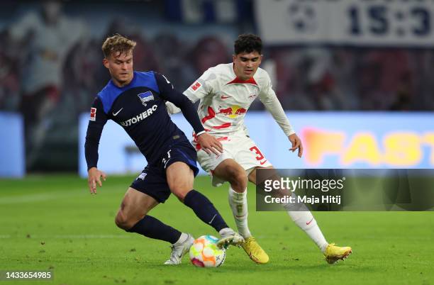 Maximilian Mittelstadt of Hertha Berlin is challenged by Hugo Novoa of RB Leipzig during the Bundesliga match between RB Leipzig and Hertha BSC at...