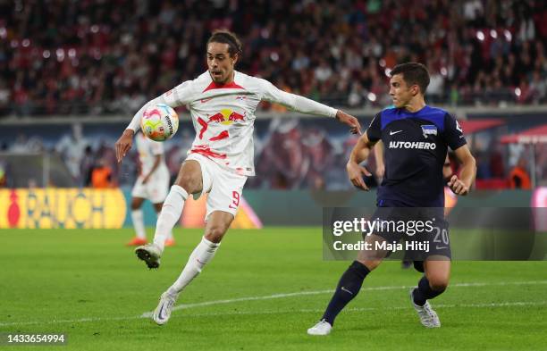 Yussuf Poulsen of RB Leipzig is challenged by Marc-Oliver Kempf of Hertha Berlin during the Bundesliga match between RB Leipzig and Hertha BSC at Red...
