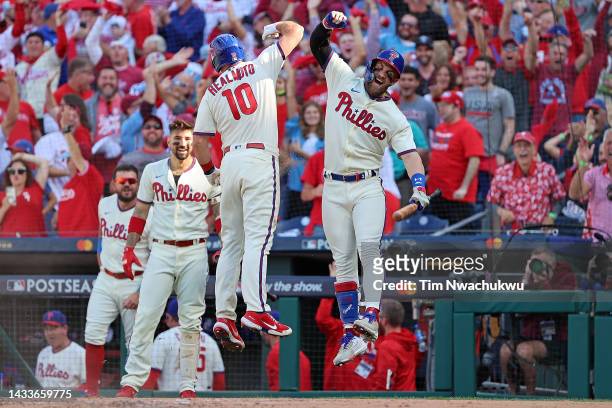 Realmuto of the Philadelphia Phillies is congratulated by Bryce Harper following an in the park home run against the Atlanta Braves during the third...