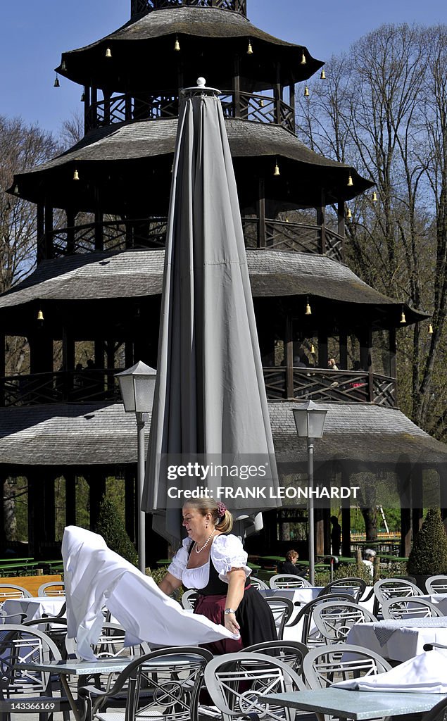 Waitress Christiane lays the cloth on a