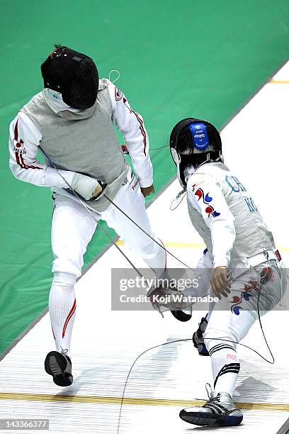 Yuki Ota of Japan competes against Choi Byung Chul of Korea in the Men's Foil Team Tableau of semifinal on day four of the 2012 Asian Fencing...