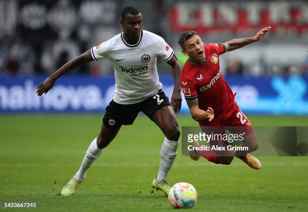 Charles Aranguiz of Leverkusen is challenged by Evan N'Dicka of Eintracht Frankfurt during the Bundesliga match between Eintracht Frankfurt and Bayer...