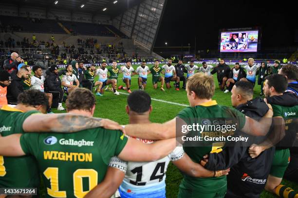 Players of Australia and Fiji huddle together following the Rugby League World Cup 2021 Pool B match between Australia and Fiji at Headingley on...