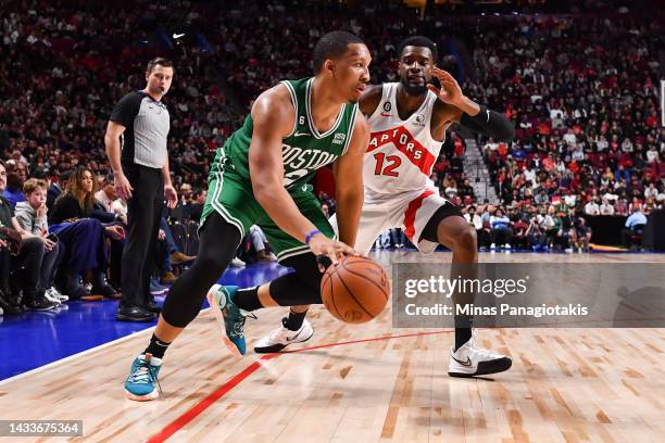 Grant Williams of the Boston Celtics dribbles the ball against Josh Jackson of the Toronto Raptors in overtime during a preseason NBA game at Centre...