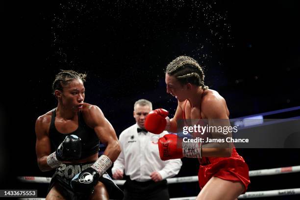 Mikaela Mayer punches Alycia Baumgardner during the IBF, IBO, WBC and WBO Super Featherweight World Title fight between Mikaela Mayer and Alycia...