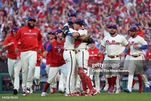 Seranthony Dominguez of the Philadelphia Phillies is congratulated by J.T. Realmuto after defeating the Atlanta Braves in game four of the National...