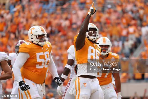 Tight end Princeton Fant of the Tennessee Volunteers celebrates with offensive lineman Darnell Wright after a big play in the second quarter against...