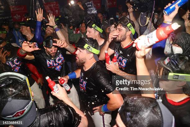 Members of the Philadelphia Phillies celebrate in the locker room after defeating the Atlanta Braves to win the National League Division Series at...
