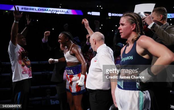 Claressa Shields celebrates as she is declared winner on points as Savannah Marshall watches on after the IBF, WBA, WBC, WBO World Middleweight Title...