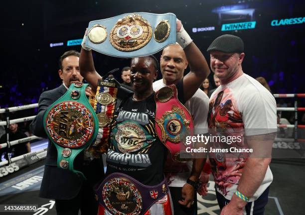 Claressa Shields and trainers pose with the WBC Elizabethan Belt and IBF, WBA, WBC, WBO World Middleweight Title belts after victory in the IBF, WBA,...