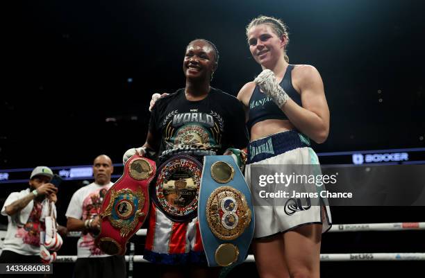 Claressa Shields poses with the WBC Elizabethan Belt and IBF, WBA, WBC, WBO World Middleweight Title belts alongside Savannah Marshall after victory...