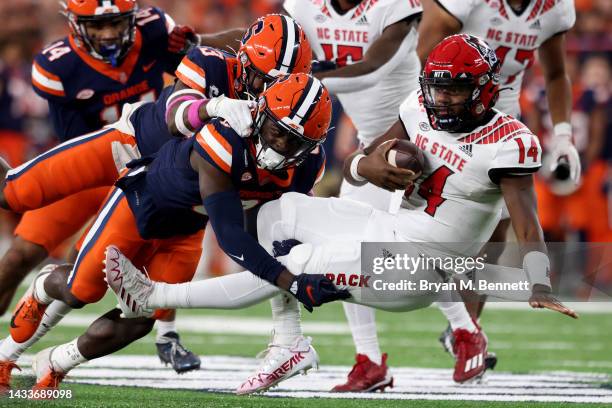 Mikel Jones and Garrett Williams of the Syracuse Orange sack Jack Chambers of the North Carolina State Wolfpack during the second quarter at JMA...