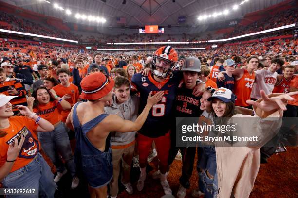 Garrett Shrader of the Syracuse Orange embraces fans after a game against the North Carolina State Wolfpack at JMA Wireless Dome on October 15, 2022...