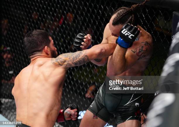 Raphael Assuncao of Brazil punches Victor Henry in a bantamweight fight during the UFC Fight Night event at UFC APEX on October 15, 2022 in Las...