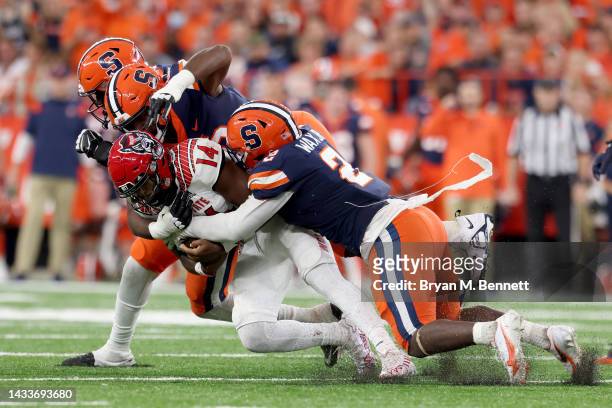Jack Chambers of the North Carolina State Wolfpack is tackled by Elijah Fuentes-Cundiff and Marlowe Wax of the Syracuse Orange during the third...
